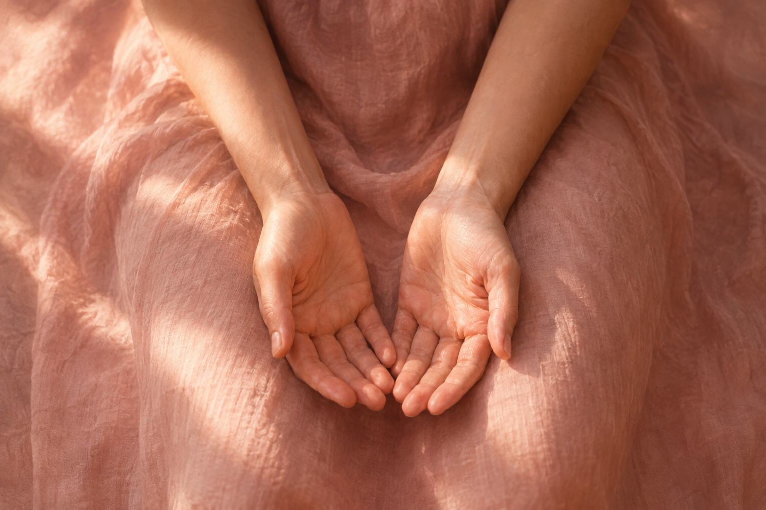 Open hands resting in a lap