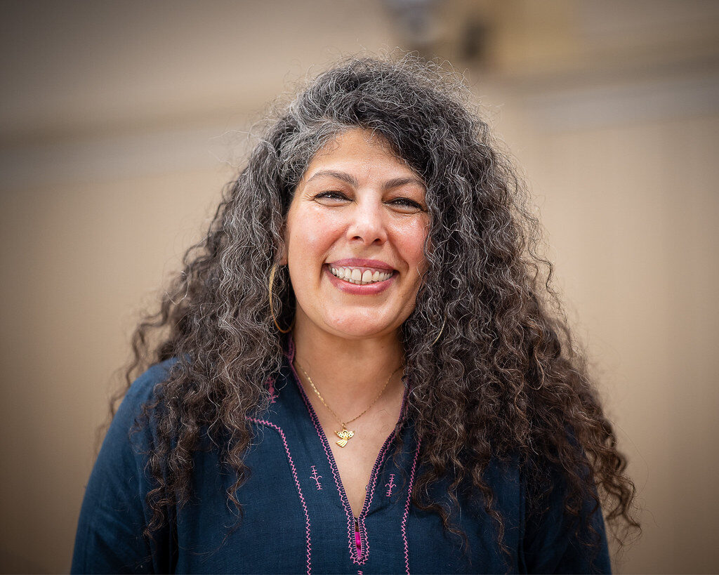 Portrait of Armineh Turgeon smiling, her silver curls loose