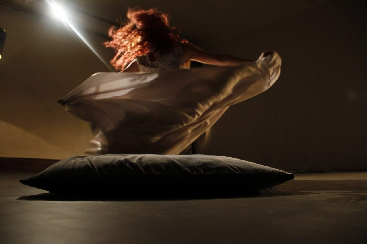 A dancer turning with flowing white cloth