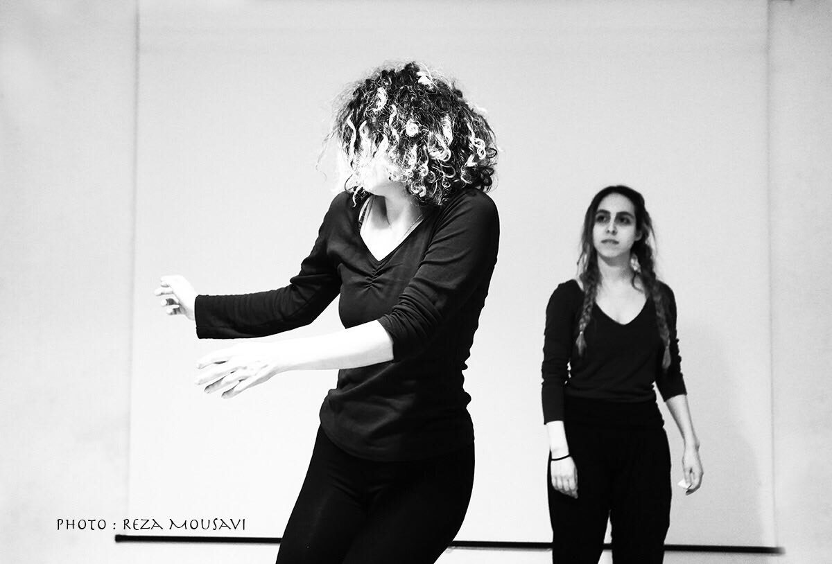 Two dancers in black, in black and white