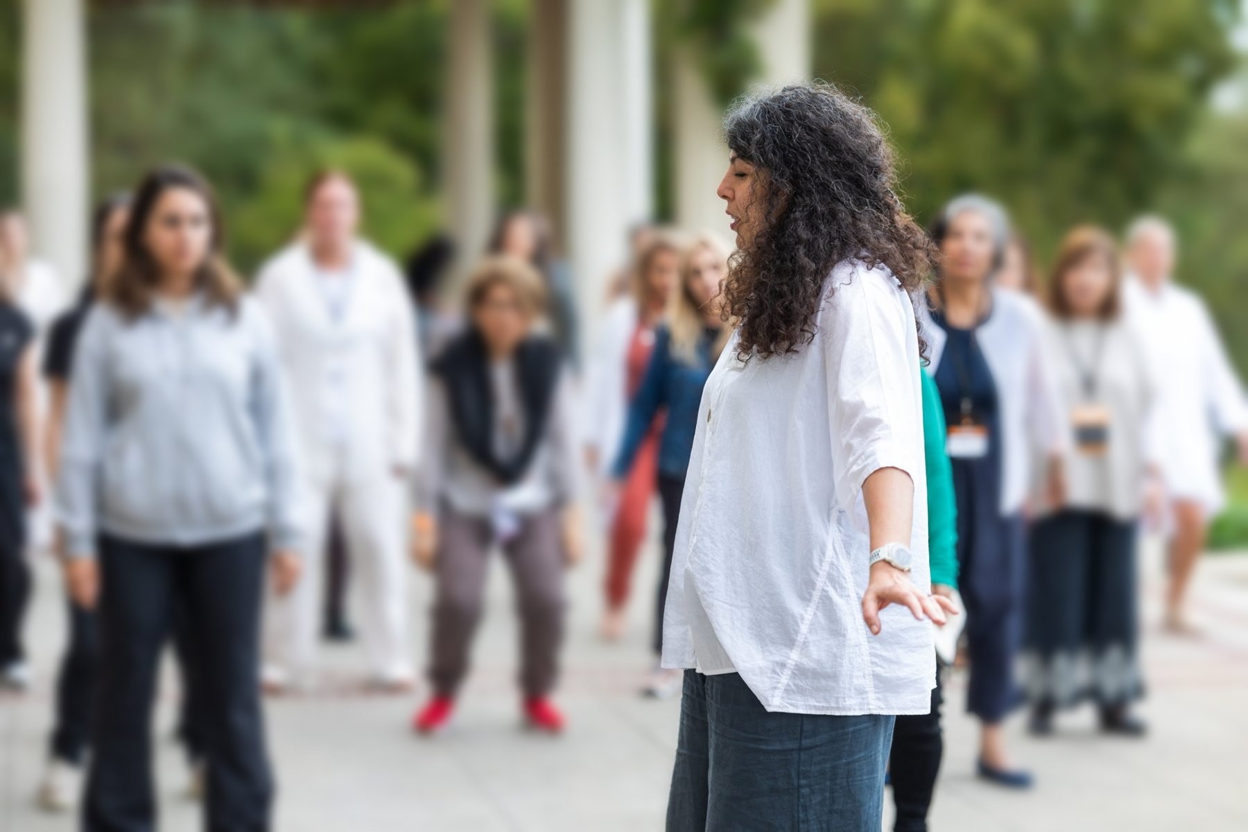 Armineh guiding a group in movement outdoors