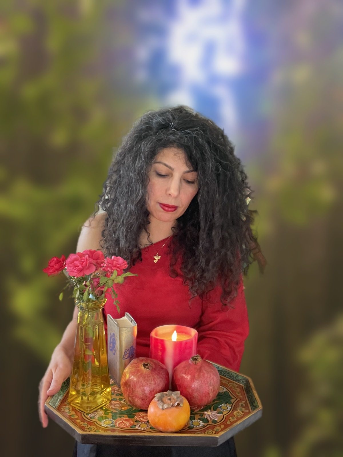 Armineh holding a ritual tray with roses, a candle and pomegranates
